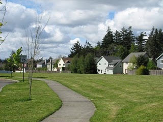 Views of the open space on the Parade Grounds on Bainbridge Island. Many homes line and back to the Parade Grounds.